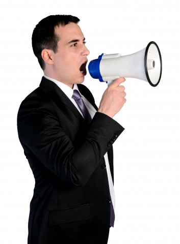 Isolated business man with loudspeaker